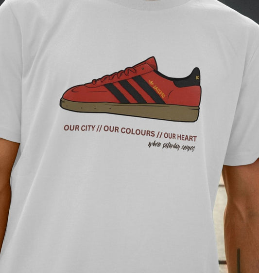 Our City Our Colours white t-shirt featuring a vibrant graphic of classic trainers.