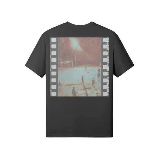 Back view of the Under The Lights Tee showcasing the filmstrip-inspired football design.