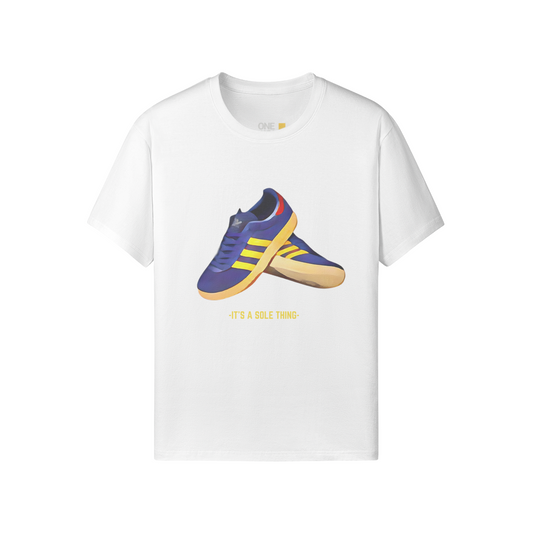 It’s a Sole Thing Tee in white by One Down Clothing, featuring a vibrant sneaker graphic on the front and subtle text detail on the back.